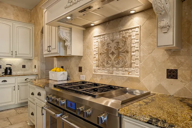 a kitchen with stainless steel appliances granite countertop a stove and a sink
