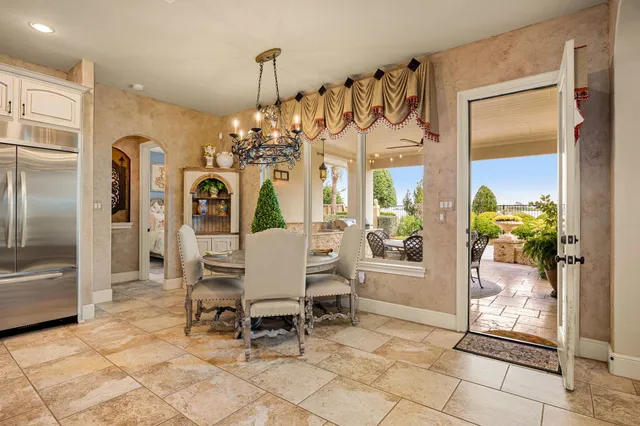 a view of a dining room with furniture and a chandelier