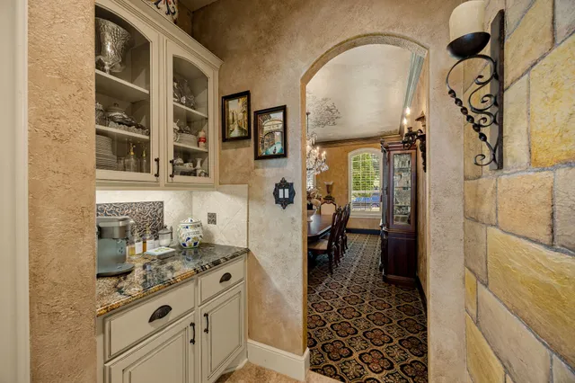 a bathroom with a granite countertop sink a mirror and shower