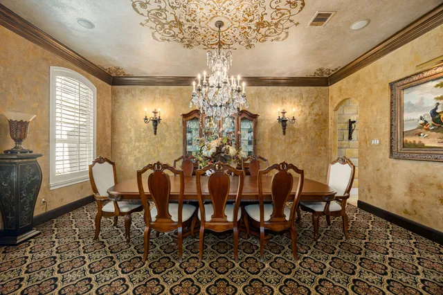 a view of a dining room with furniture and chandelier