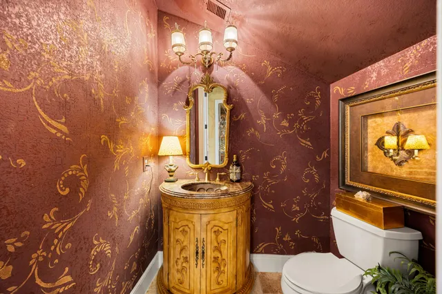 a bathroom with a toilet sink and mirror