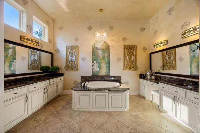 a kitchen with stainless steel appliances a sink and a large mirror