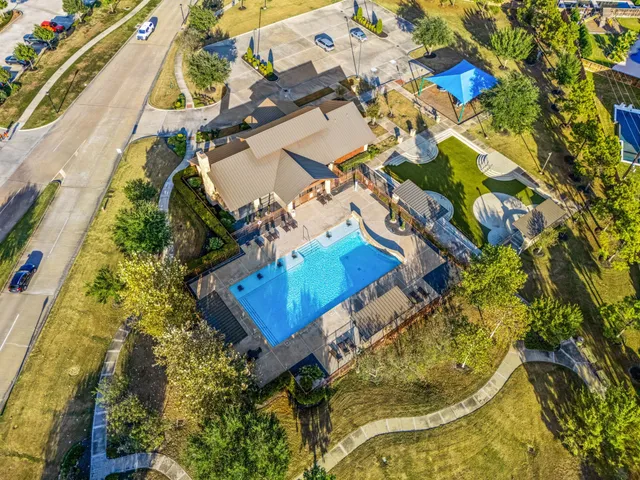 an aerial view of a house with a swimming pool