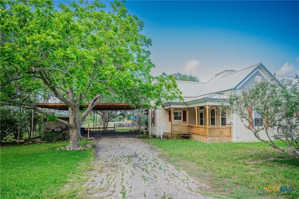 a front view of house with yard and green space