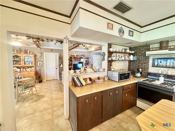 a kitchen with a sink stove and cabinets
