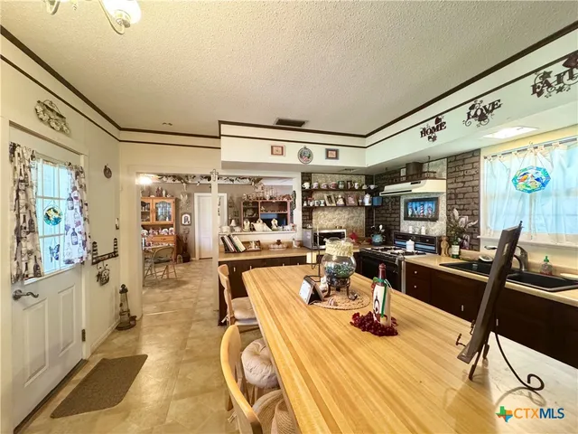 a view of a dining room with furniture a chandelier and wooden floor