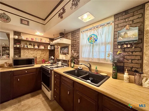 a kitchen that has a sink and a stove