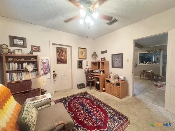 a bedroom with furniture and a rug