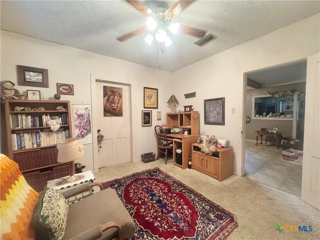 a bedroom with furniture and a rug