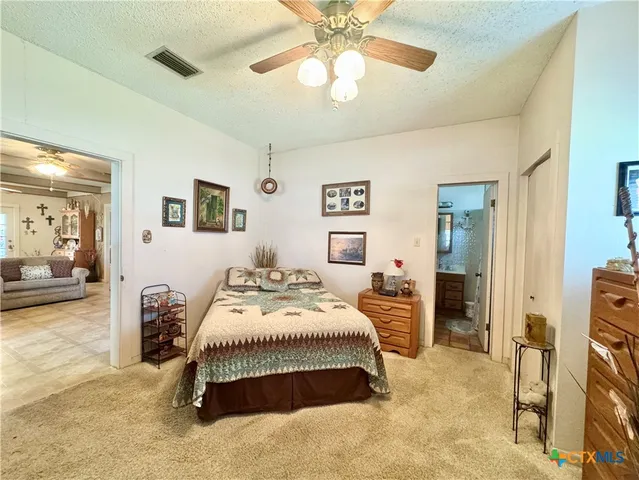 a bedroom with a bed and ceiling fan