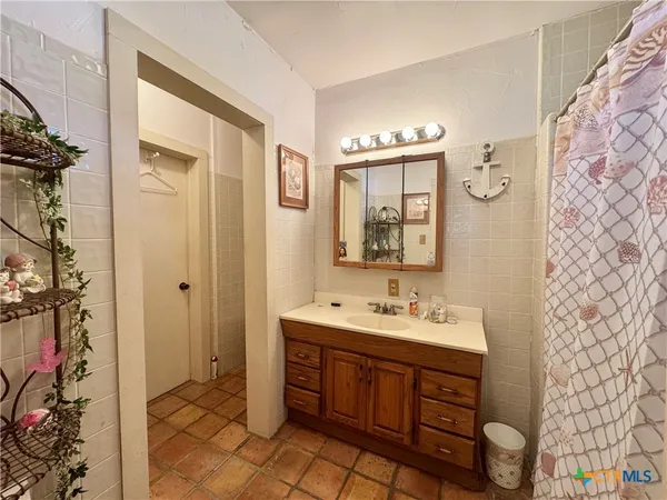 a bathroom with a sink a toilet a shower and a mirror