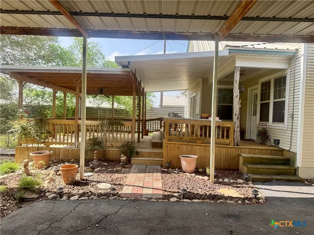 a front view of a house with a fountain