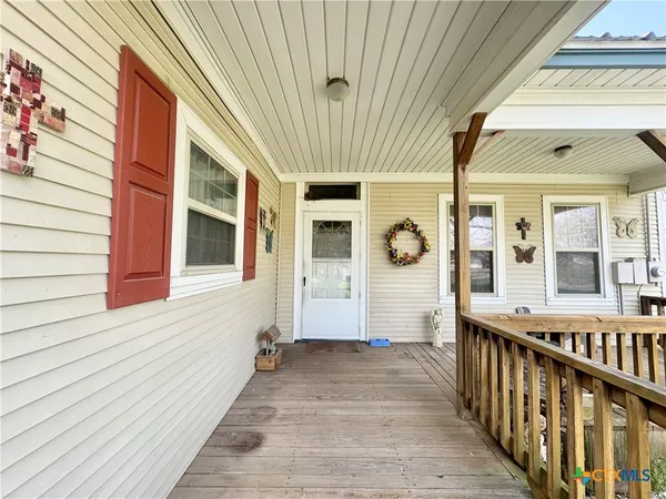 a view of a porch with wooden floor and stairs