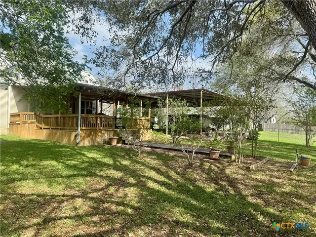 a view of swimming pool with a table and chairs under an umbrella