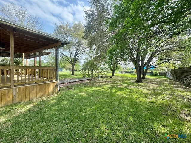 a view of a house with backyard porch and sitting area