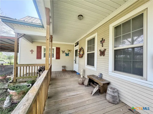 a balcony with wooden floor and furniture