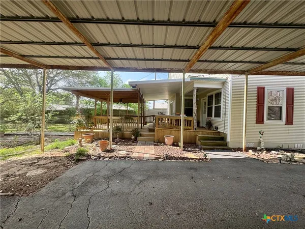 a view of a house with a yard and tree s