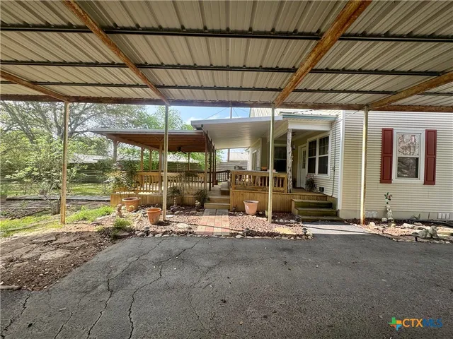 a view of a house with a yard and tree s