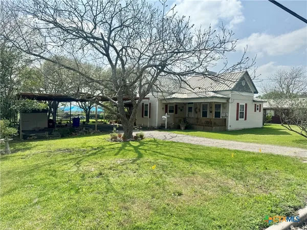 a view of a house with a backyard