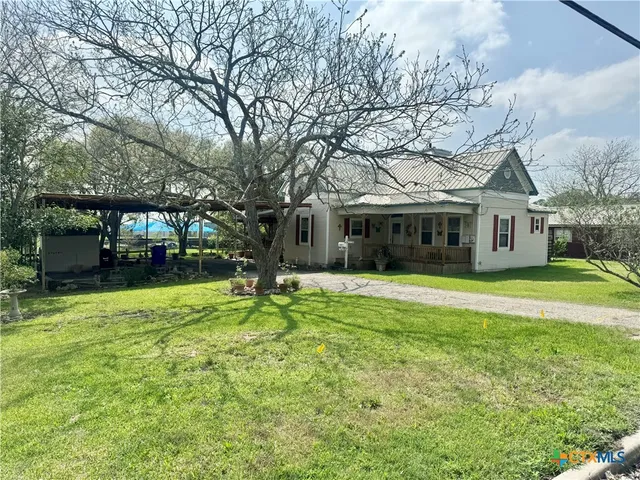 a view of a house with a backyard