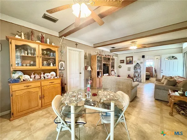 a dining room with furniture and large window