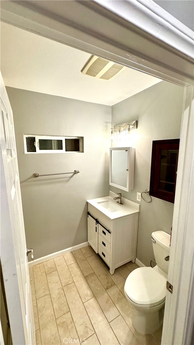 5010 3rd Avenue Los Angeles, CA 90043 - Photo 11 of 13 a bathroom with a sink a toilet and mirror
