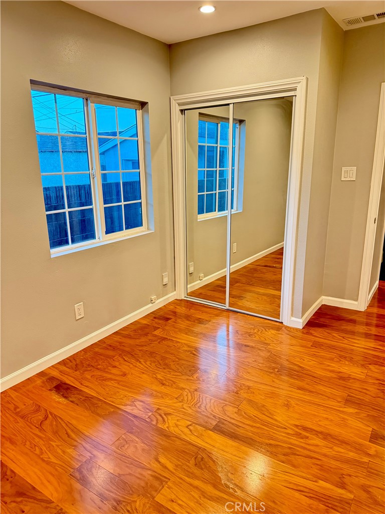 5010 3rd Avenue Los Angeles, CA 90043 - Photo 7 of 13 a view of an empty room with wooden floor and windows
