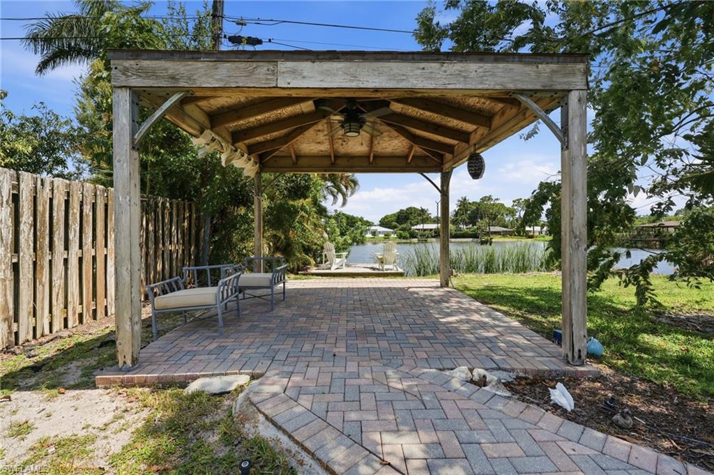 1316 Rordon Avenue Naples, FL 34103 - Photo 33 of 38 Shaded outdoor patio featuring a wood pergola structure with a ceiling fan