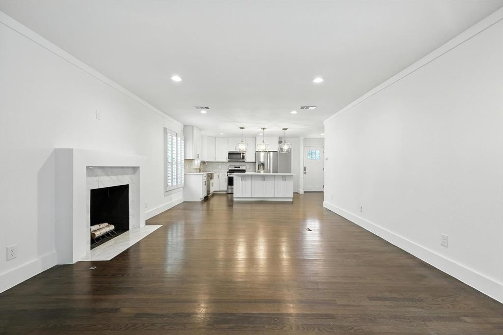 6116 St Moritz Avenue Dallas, TX 75214 - Photo 16 of 40 a view of kitchen with furniture and fireplace