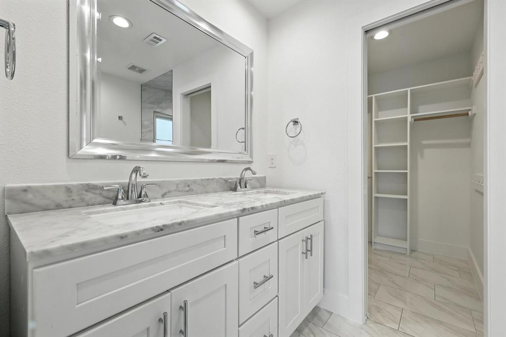 6116 St Moritz Avenue Dallas, TX 75214 - Photo 21 of 40 a bathroom with a granite countertop sink and a mirror