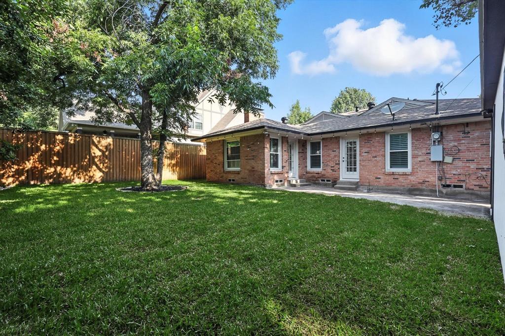 6116 St Moritz Avenue Dallas, TX 75214 - Photo 36 of 40 a front view of house with yard and green space