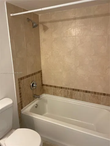 a bathroom with a toilet and a bathtub
