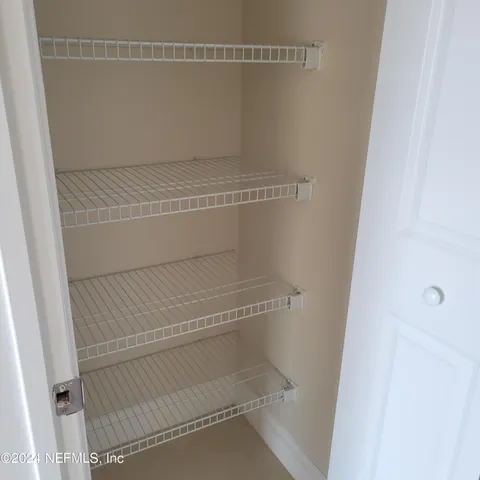 a view of a kitchen with a sink and a refrigerator