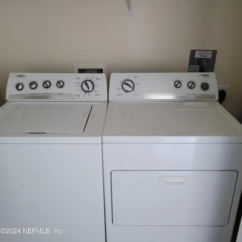 a view of a living room with hardwood floor and a view of kitchen