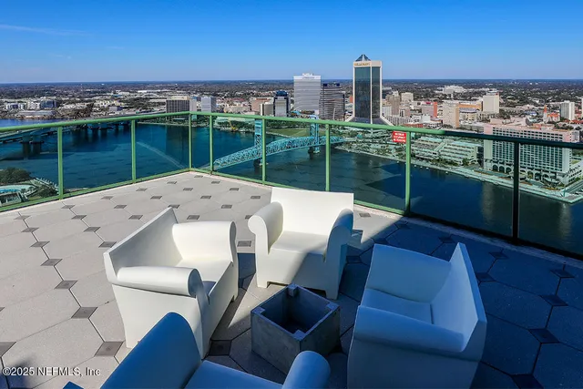 a lobby with furniture and floor to ceiling window