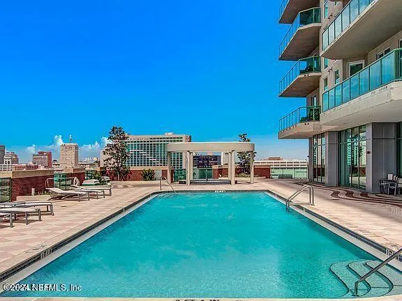 a view of a house with swimming pool and sitting area