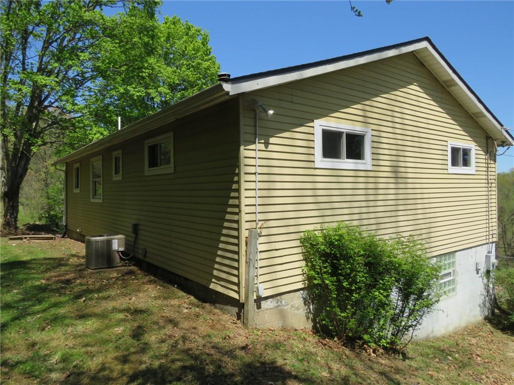 21 Daisytown Road Brownsville, PA 15417 - Photo 25 of 31 a view of a backyard with plants and a barbeque