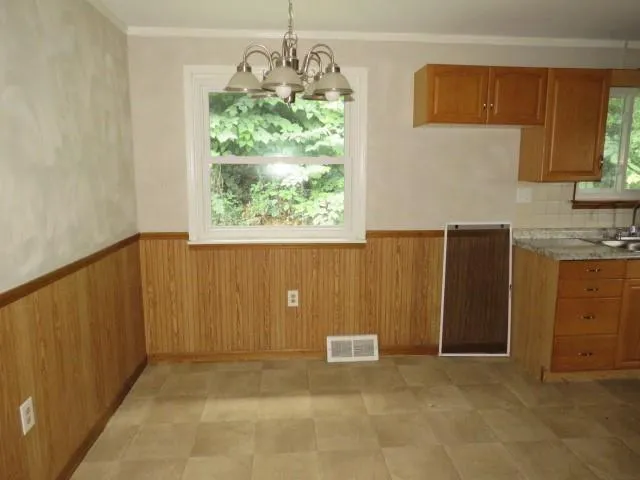 a view of kitchen with window and cabinets