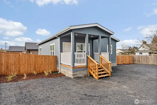 a view of backyard with wooden fence
