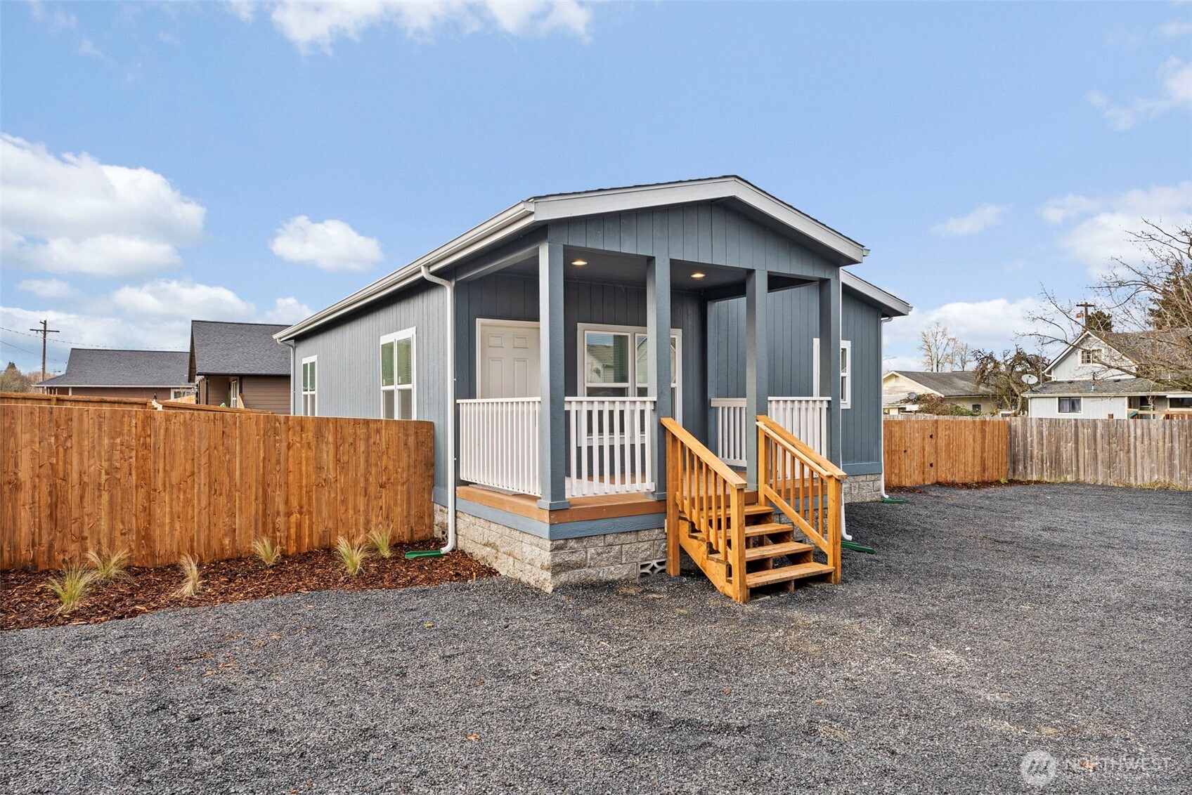 a view of backyard with wooden fence