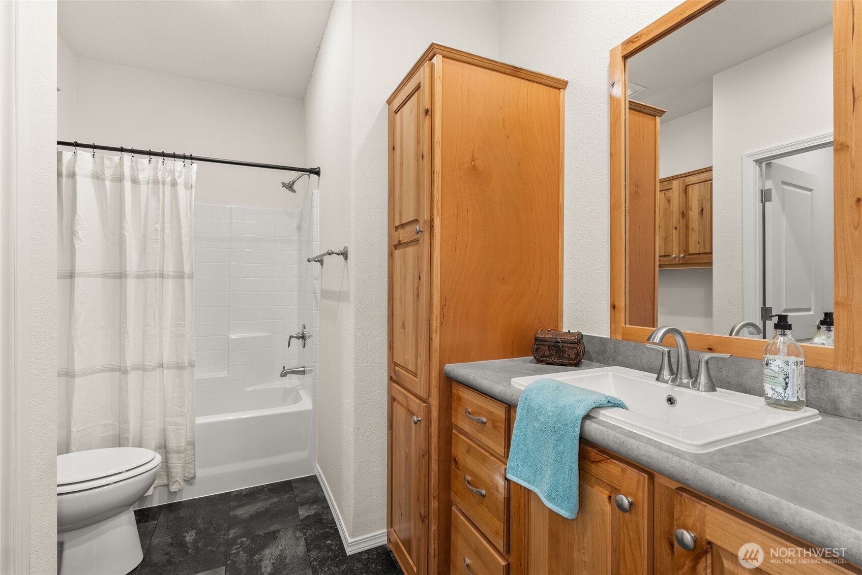 1257 Southwest Elzina Street Chehalis, WA 98532 - Photo 18 of 28 a bathroom with a granite countertop sink toilet and shower