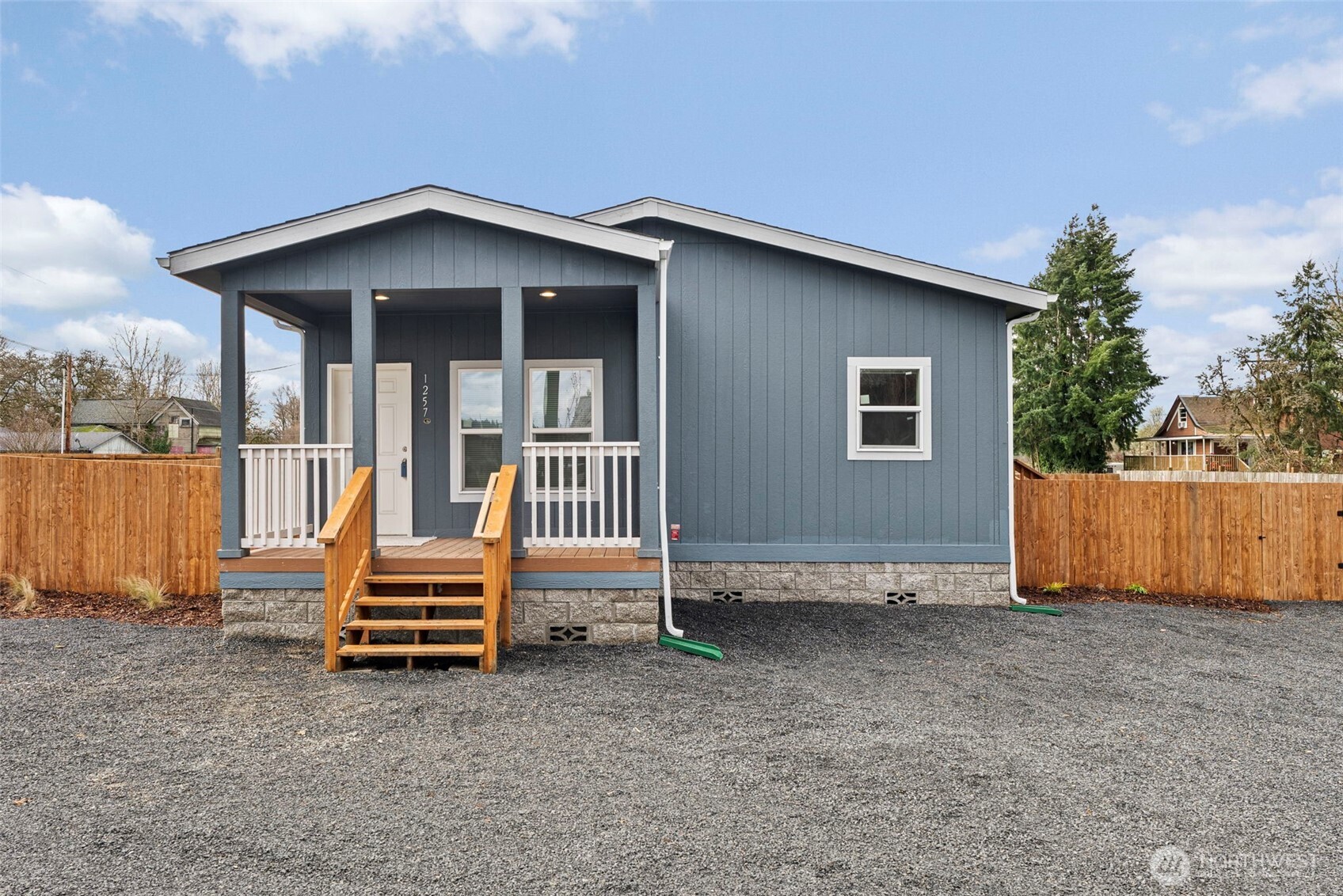 1257 Southwest Elzina Street Chehalis, WA 98532 - Photo 2 of 28 an outdoor view of house with deck and backyard