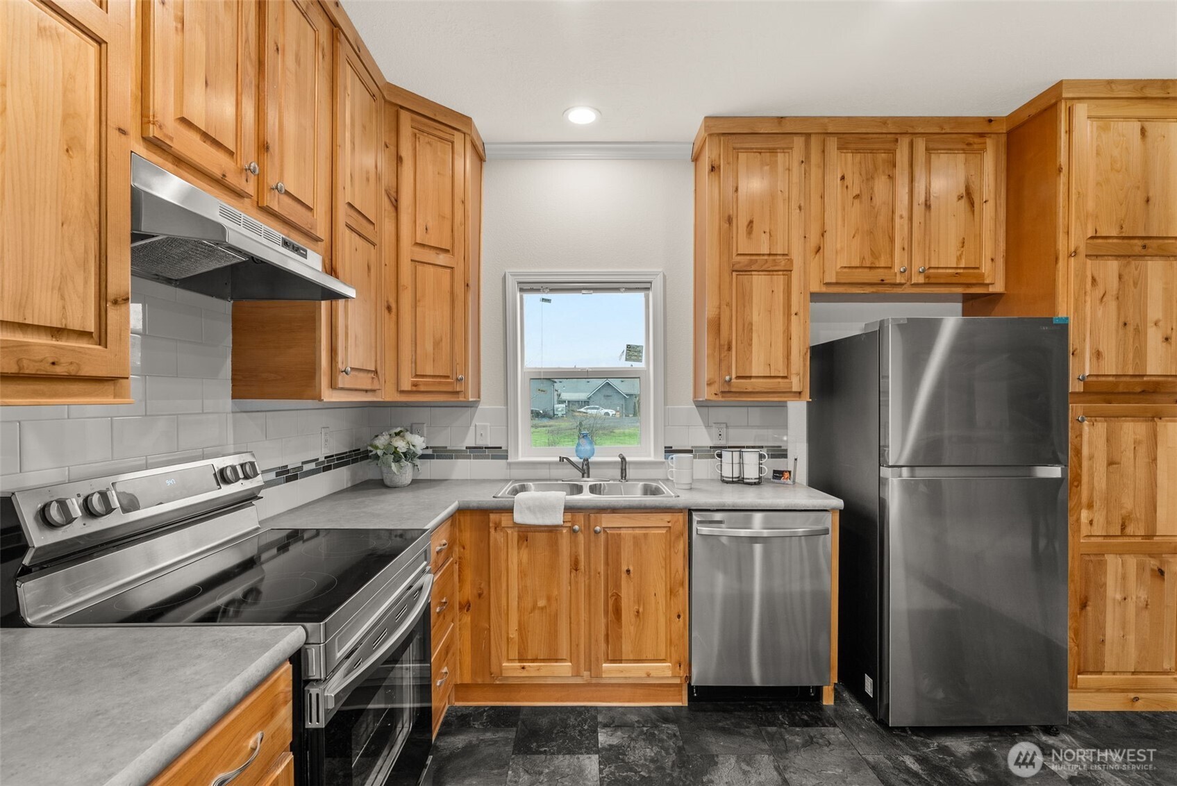1257 Southwest Elzina Street Chehalis, WA 98532 - Photo 5 of 28 a kitchen with a refrigerator a stove a sink and a cabinets
