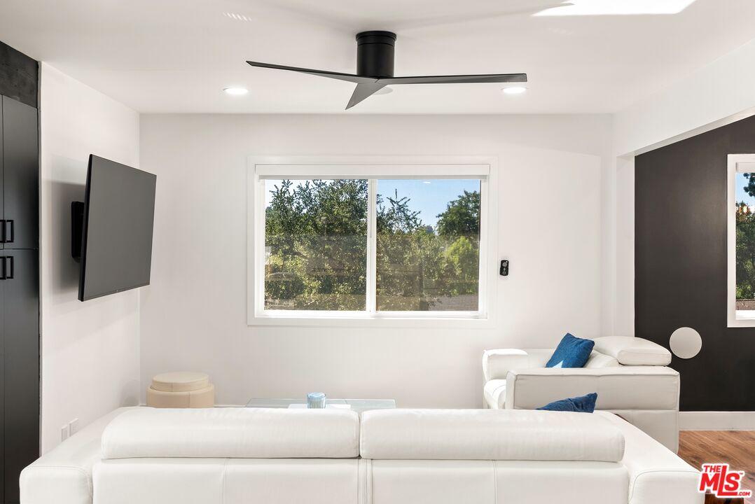 4118 Oak Hollow Road Calabasas, CA 91302 - Photo 18 of 55 a living room with furniture and a flat screen tv