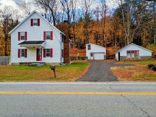 a view of houses with swimming pool and large trees