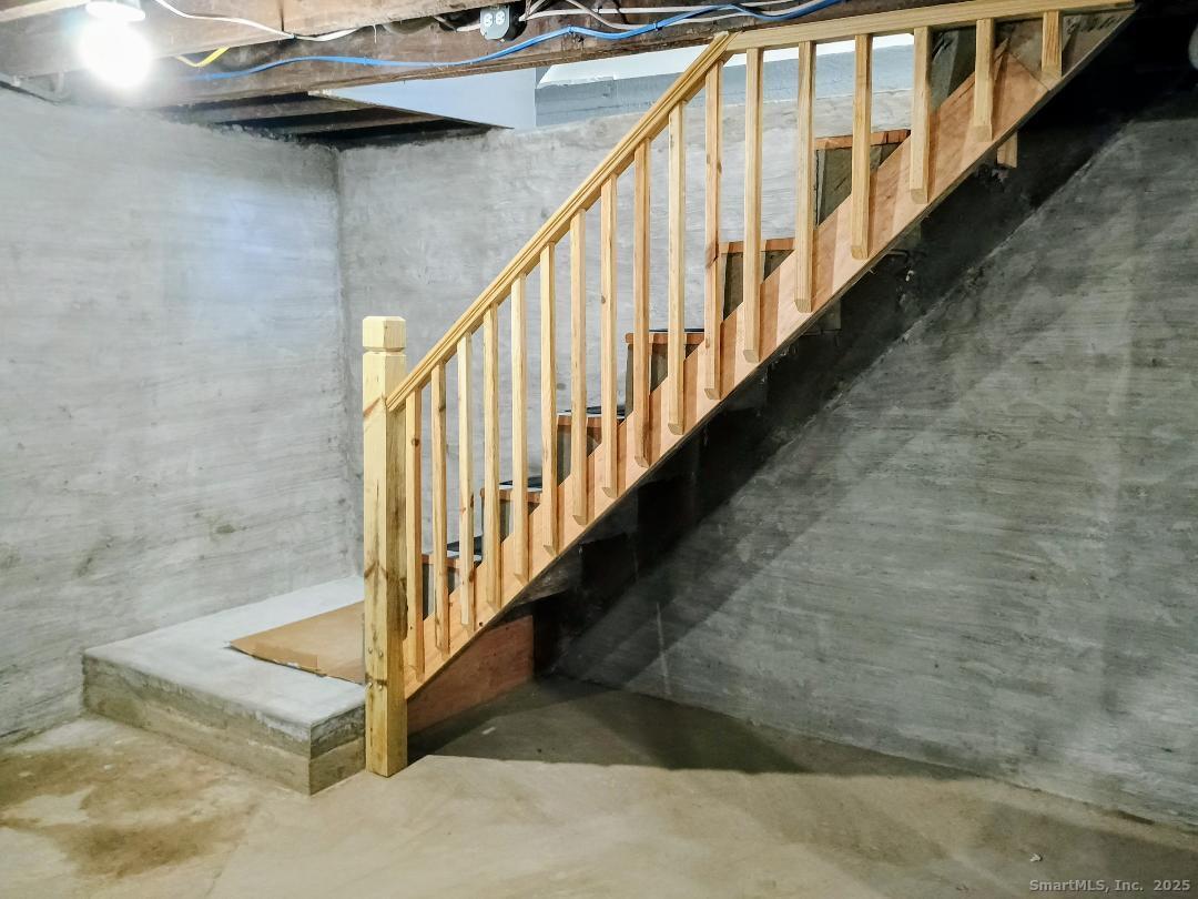 633 Wauregan Road Brooklyn, CT 06234 - Photo 12 of 15 a view of staircase with lots of frames on wall and wooden floor