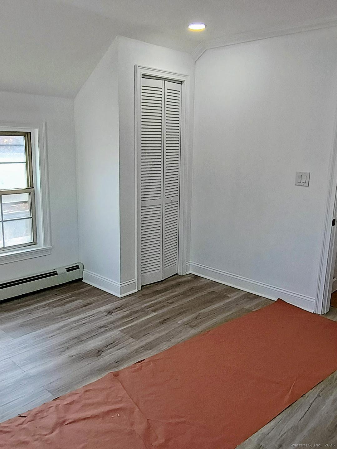 633 Wauregan Road Brooklyn, CT 06234 - Photo 6 of 15 an empty room with wooden floor