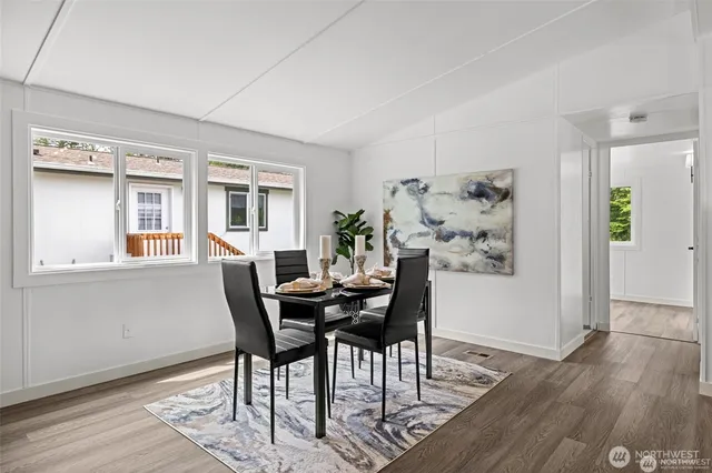 a view of a dining room with furniture window and wooden floor