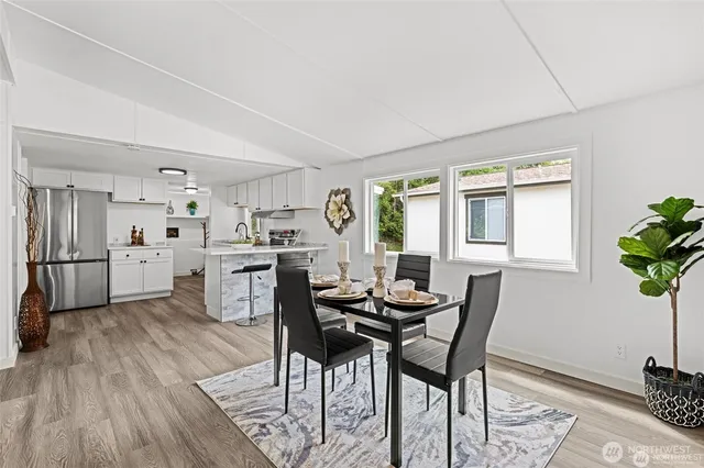 a view of a dining room with furniture and a potted plant