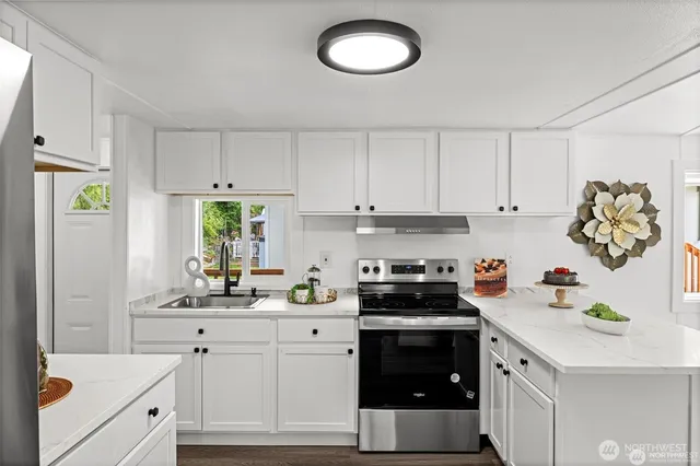 a kitchen with a white cabinets and white appliances